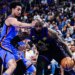 LeBron James drives past Jared McCain in an NBA game.