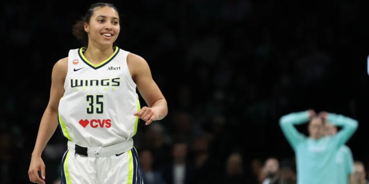 Dallas Wings’ Azzi Fudd (35) reacts after hitting a three-point basket.