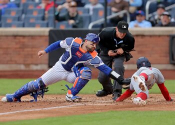 New York Mets catcher Luis Torrens tagging out Washington Nationals second baseman Nasim Nunez at home plate.