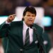 Mark Gastineau gestures while speaking into a microphone.