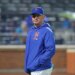 New York Mets manager Carlos Mendoza walks back to the dugout during a game.