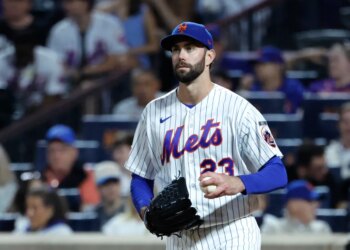 New York Mets pitcher David Peterson reacts after Cincinnati Reds left fielder JJ Bleday scores.