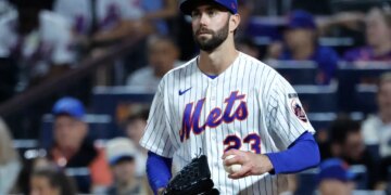 New York Mets pitcher David Peterson reacts after Cincinnati Reds left fielder JJ Bleday scores.