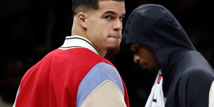 Brooklyn Nets player Michael Porter Jr. on the bench during a game.