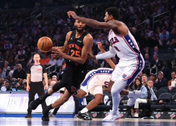New York Knicks guard Mikal Bridges drives the ball past Philadelphia 76ers forward Paul George.