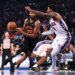 New York Knicks guard Mikal Bridges drives the ball past Philadelphia 76ers forward Paul George.