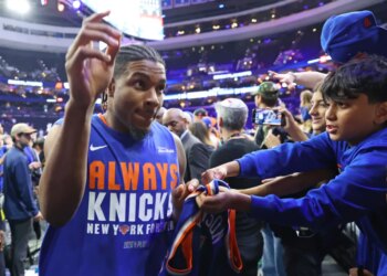Miles McBride #2 of the New York Knicks signing autographs for fans at the Xfinity Mobile Arena.