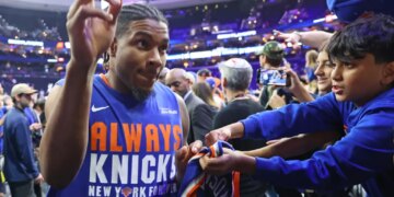 Miles McBride #2 of the New York Knicks signing autographs for fans at the Xfinity Mobile Arena.