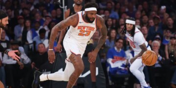 New York Knicks center Mitchell Robinson #23 chasing a loose ball.