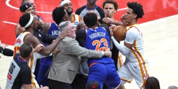 New York Knicks center Mitchell Robinson fighting with Atlanta Hawks guard Dyson Daniels during an NBA Playoffs game.