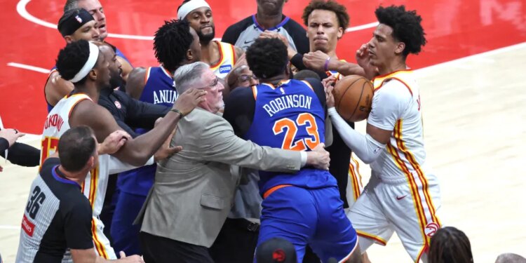 New York Knicks center Mitchell Robinson fighting with Atlanta Hawks guard Dyson Daniels during an NBA Playoffs game.
