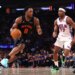 New York Knicks forward Og Anunoby #8 drives to the basket as Philadelphia 76ers guard Vj Edgecombe #77 gives chase during the third quarter.
