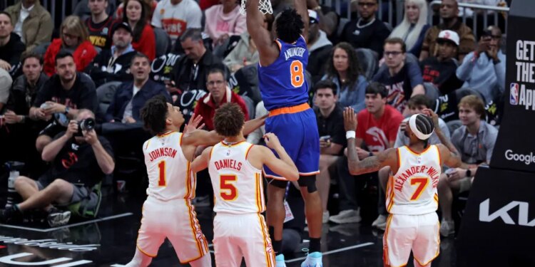 New York Knicks forward Og Anunoby (8) slams the ball during a game against the Atlanta Hawks.