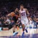 New York Knicks player Og Anunoby driving to the basket with a Philadelphia 76ers player guarding him during an NBA playoffs game.