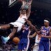 New York Knicks forward Og Anunoby #8 slams the ball over Philadelphia 76ers forward Paul George #8 and Philadelphia 76ers guard Vj Edgecombe #77 during the third quarter.