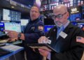 Specialist Anthony Matesic and trader Fred Demarco working on the floor of the New York Stock Exchange.