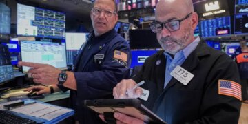 Specialist Anthony Matesic and trader Fred Demarco working on the floor of the New York Stock Exchange.