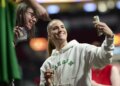 Sabrina Ionescu, who starred for the Oregon Ducks, takes a selfie with a fan before the Liberty's 98-96 loss to the Fire on May 12, 2026 in Portland, Ore.