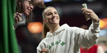 Sabrina Ionescu, who starred for the Oregon Ducks, takes a selfie with a fan before the Liberty's 98-96 loss to the Fire on May 12, 2026 in Portland, Ore.