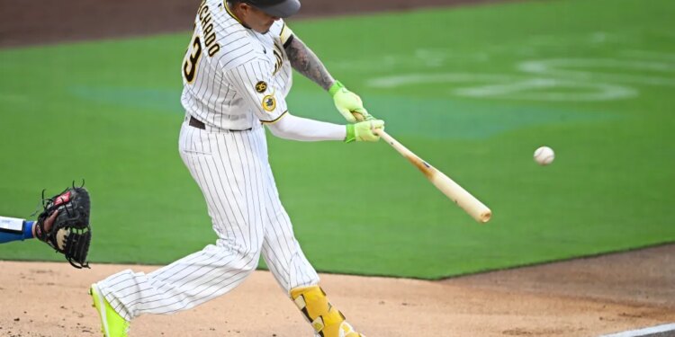 Manny Machado hitting a baseball.