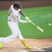 Manny Machado hitting a baseball.