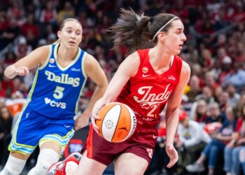 Indiana Fever guard Caitlin Clark (22) dribbles the ball while Dallas Wings guard Paige Bueckers (5) defends in the first half at Gainbridge Fieldhouse.