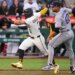 Pittsburgh Pirates' Nick Gonzales running past Colorado Rockies pitcher Jose Quintana in a rundown.