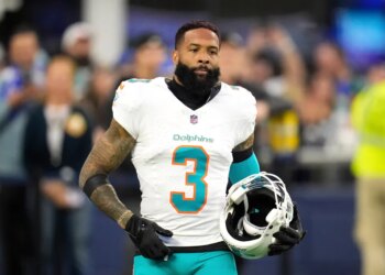 Odell Beckham Jr. with his helmet off, wearing a white Miami Dolphins jersey with the number 3.