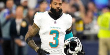 Odell Beckham Jr. with his helmet off, wearing a white Miami Dolphins jersey with the number 3.