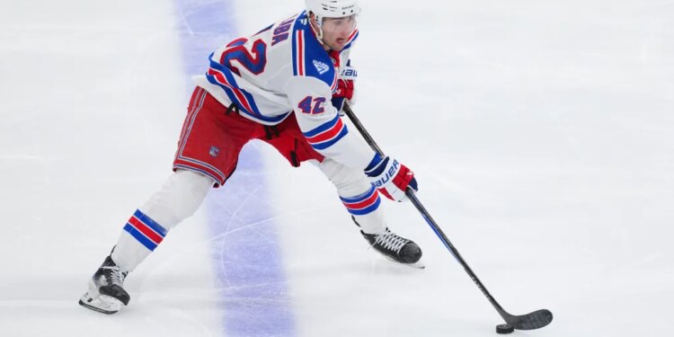New York Rangers center Noah Laba skates with the puck.