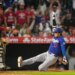 Shohei Ohtani sliding into a base as Logan O'Hoppe stands ready to catch.