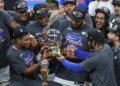 New York Knicks players celebrating with the Eastern Conference Champions trophy.
