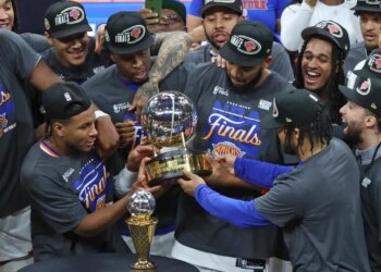 New York Knicks players celebrating with the Eastern Conference Champions trophy.