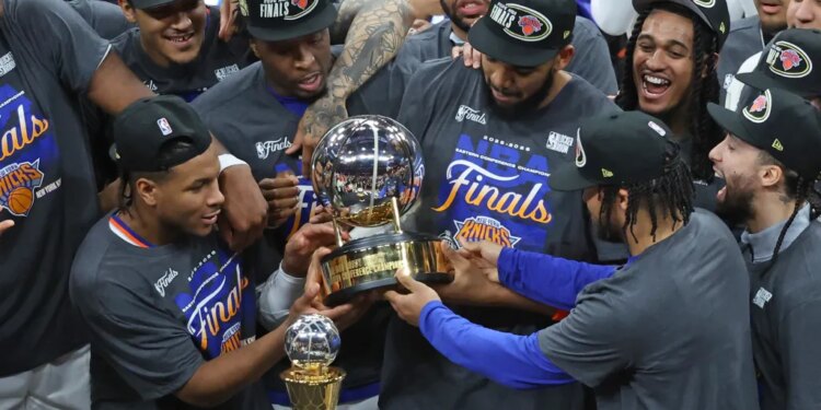 New York Knicks players celebrating with the Eastern Conference Champions trophy.