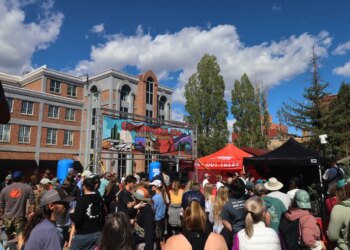 A crowd gathers to watch runners finish the Cocodona 250 ultramarathon in downtown Flagstaff, Arizona.