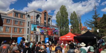 A crowd gathers to watch runners finish the Cocodona 250 ultramarathon in downtown Flagstaff, Arizona.