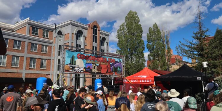 A crowd gathers to watch runners finish the Cocodona 250 ultramarathon in downtown Flagstaff, Arizona.