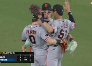 Three Giants outfielders celebrate their 9-3 win over the Dodgers.