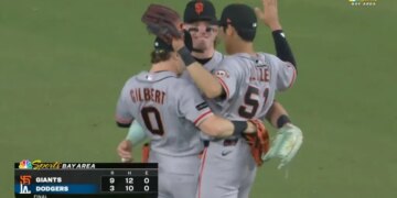 Three Giants outfielders celebrate their 9-3 win over the Dodgers.