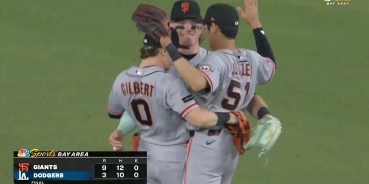 Three Giants outfielders celebrate their 9-3 win over the Dodgers.