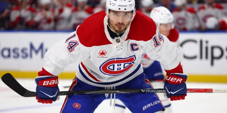 Montréal Canadiens center Nick Suzuki (14) lines up for a face-off during the second period in Game 1 of a second-round NHL hockey Stanley Cup playoff series against the Buffalo Sabres, Wednesday, May 6, 2026, in Buffalo, N.Y. (AP Photo/Jeffrey T. Barnes)