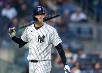 Spencer Jones of the New York Yankees on the field with a bat over his shoulder.