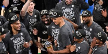 Victor Wembanyama, holding the Western Conference MVP trophy he won, celebrates with teammates after the Spurs' 111-103 Game 7 win over the Thunder on May 30, 2026 in Oklahoma City.