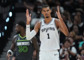 Victor Wembanyama of the San Antonio Spurs reacts to a play during a basketball game.