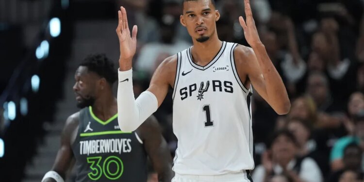 Victor Wembanyama of the San Antonio Spurs reacts to a play during a basketball game.