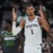 Victor Wembanyama of the San Antonio Spurs reacts to a play during a basketball game.