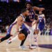 Jalen Brunson of the New York Knicks drives to the basket with Joel Embiid of the Philadelphia 76ers guarding him.