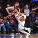 New York Knicks guard Jalen Brunson #11 drives to the basket as Cleveland Cavaliers forward Dean Wade #32 defends.