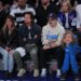 Actors Jason Bateman and Jason Sudeikis sitting courtside with their families at an NBA game.
