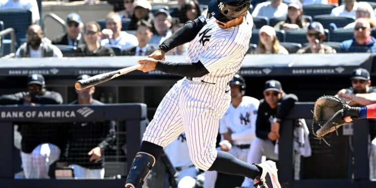 New York Yankees player Trent Grisham swings at a baseball during a game.
